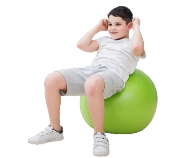 Child performing physiotherapy exercises on a therapy ball