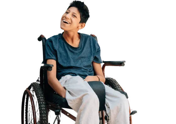 Smiling child in a wheelchair wearing a black t-shirt, looking at the camera