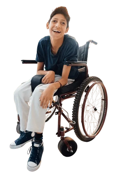Smiling child in a wheelchair wearing a black t-shirt, looking at the camera