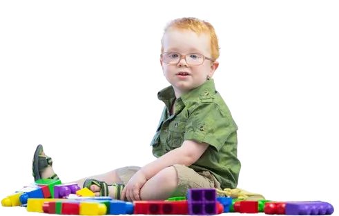 Child sitting on a colourful play mat