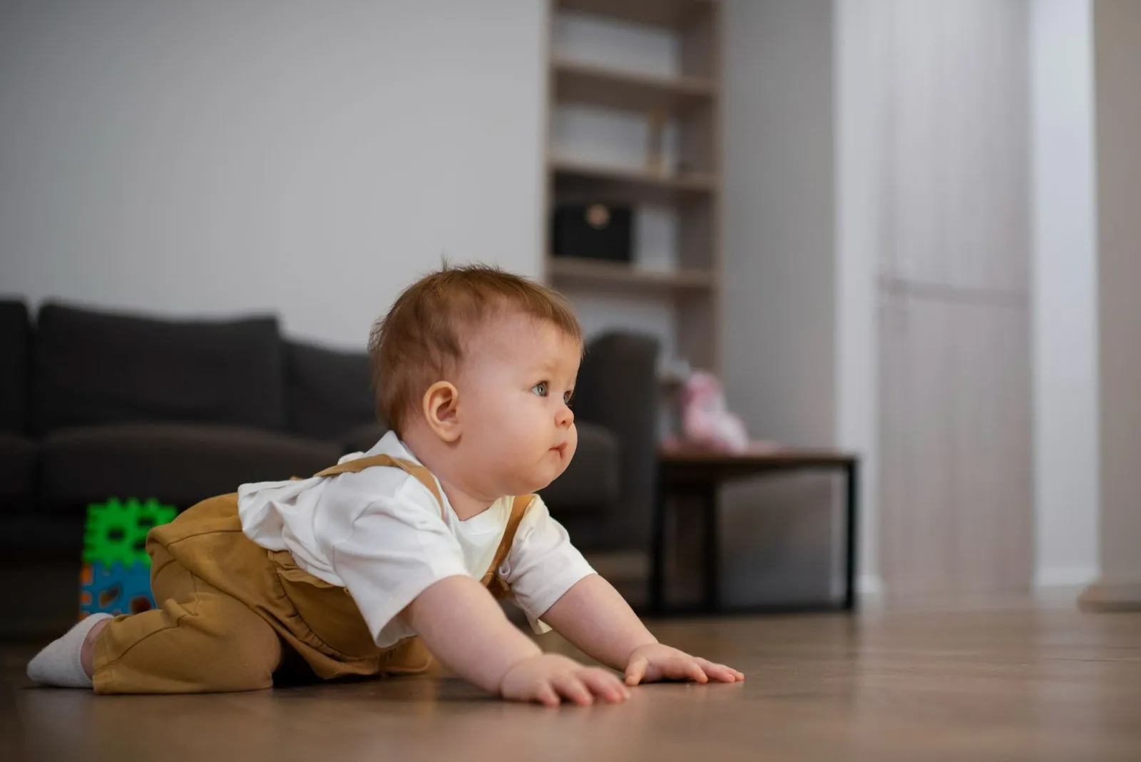 Baby crawling on the floor, an early milestone before walking, showing when do babies start walking progression