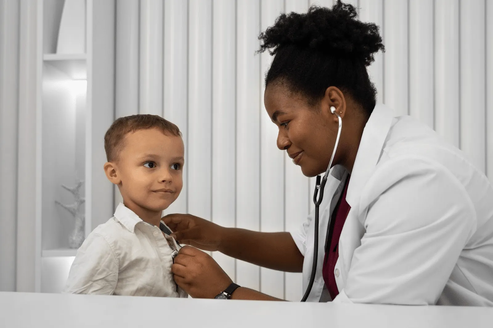 Child in mask attending session at paediatric physical therapy clinic