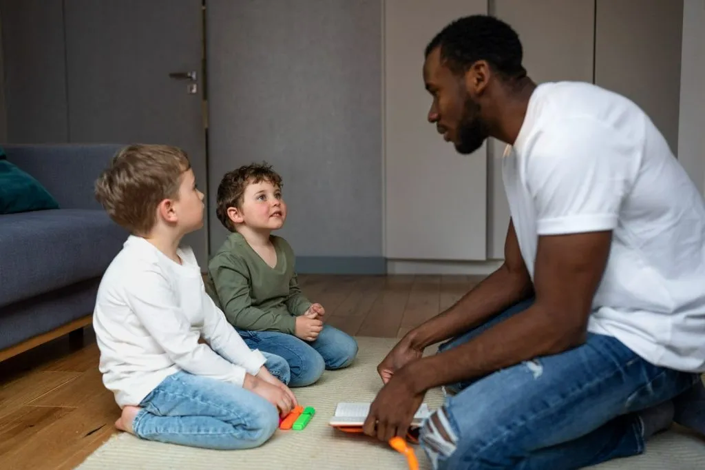 Therapist supporting children with communication and motor skills in hypermobility autism spectrum disorder