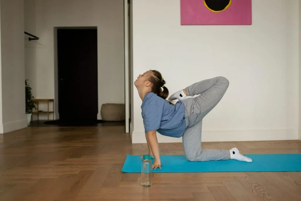 Child practising yoga at home to improve coordination and posture in hypermobility autism spectrum disorder