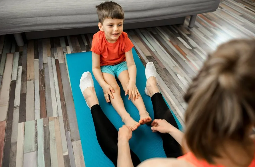 Child doing physiotherapy exercises with a therapist during a home visit physio session in Sydney