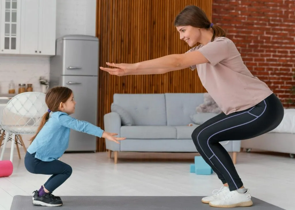 Paediatric physiotherapist guiding child through home exercise to strengthen movement and support poor coordination in child