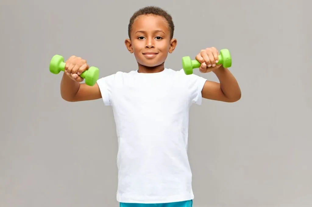 Child practising strength exercises during physiotherapy to build coordination and confidence