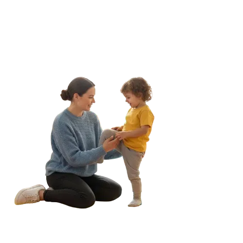 A physiotherapist gently holding a child's leg while performing physiotherapy exercises.
