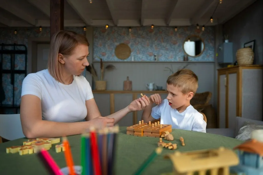Physiotherapist guiding motor skills during ASD early intervention session